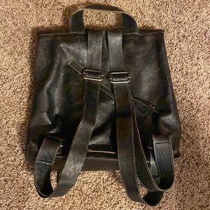 Aged Dark Brown Leather fold over backpack bag.